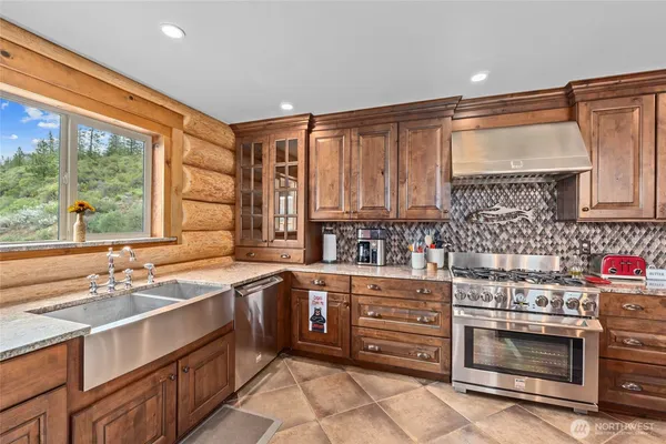 a kitchen with stainless steel appliances a stove sink and cabinets