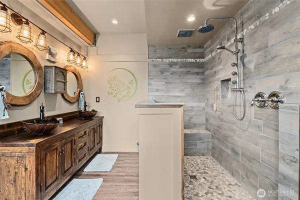 a bathroom with a sink a toilet and shower