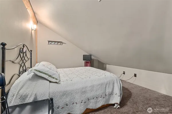 a bedroom with a bed and a night stand
