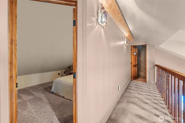 a view of a hallway with wooden floor and entryway