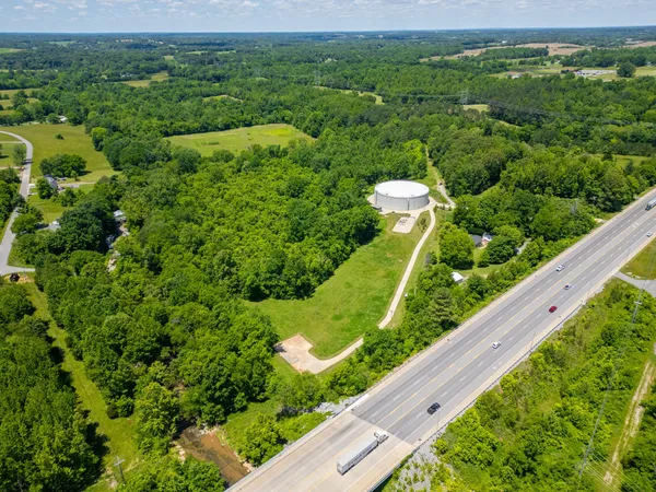 a view of a big yard with large trees