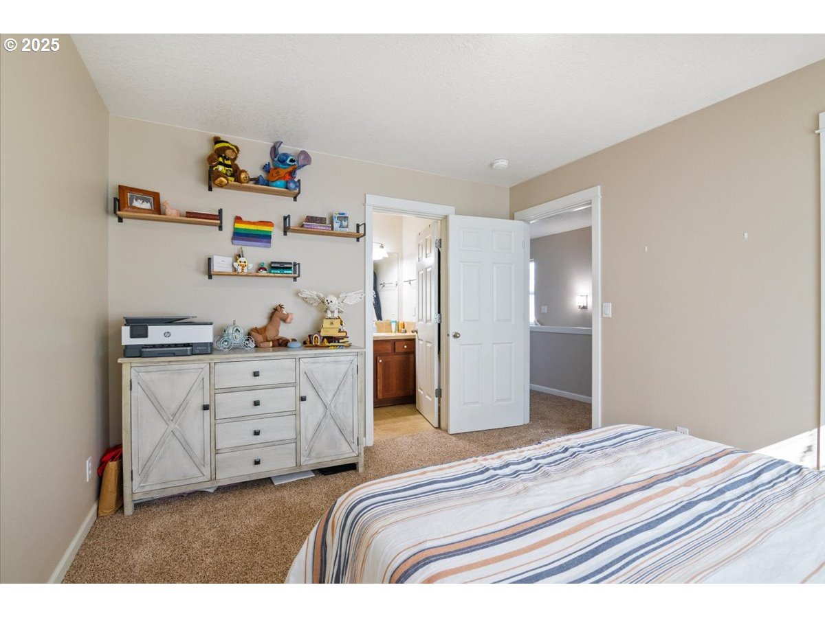 4135 Geranium Loop Northeast Salem, OR 97305 - Photo 12 of 18 a bedroom with a bed and cabinets