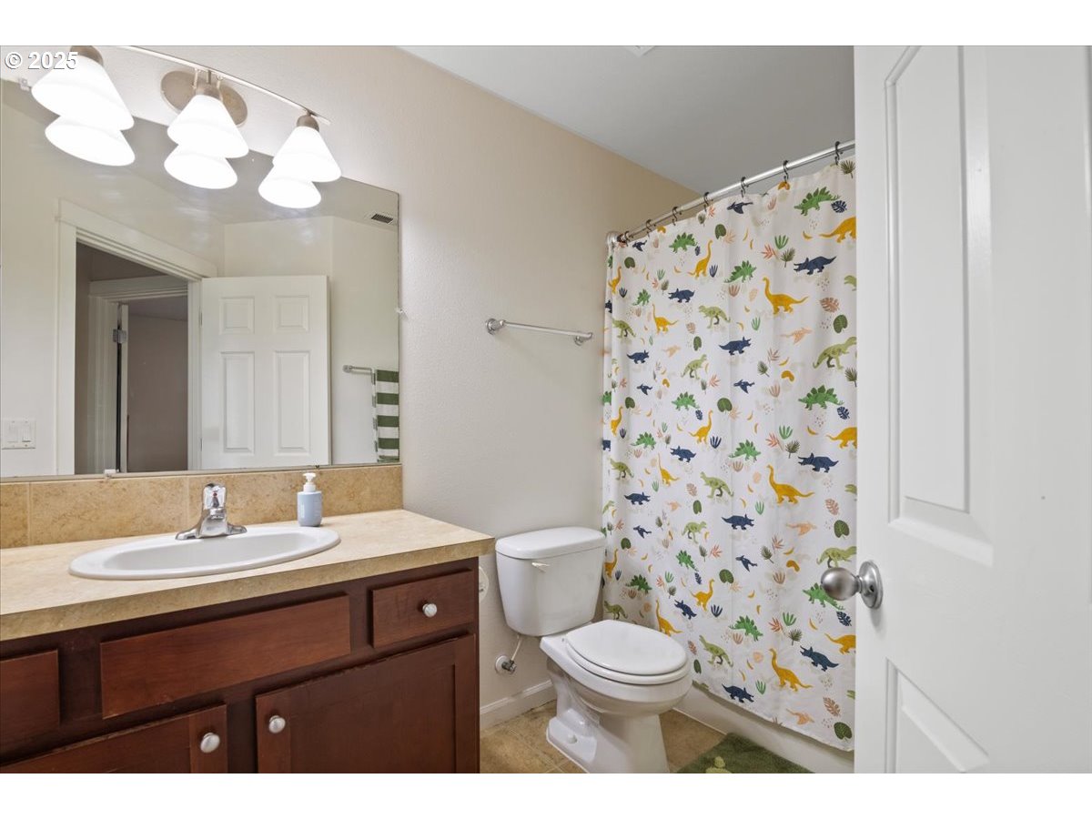 4135 Geranium Loop Northeast Salem, OR 97305 - Photo 13 of 18 a bathroom with a sink a toilet and a mirror