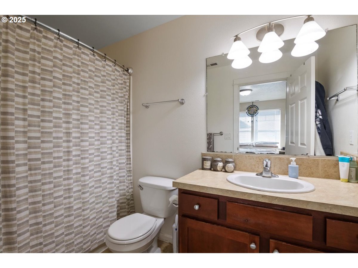4135 Geranium Loop Northeast Salem, OR 97305 - Photo 14 of 18 a bathroom with a sink a toilet and mirror