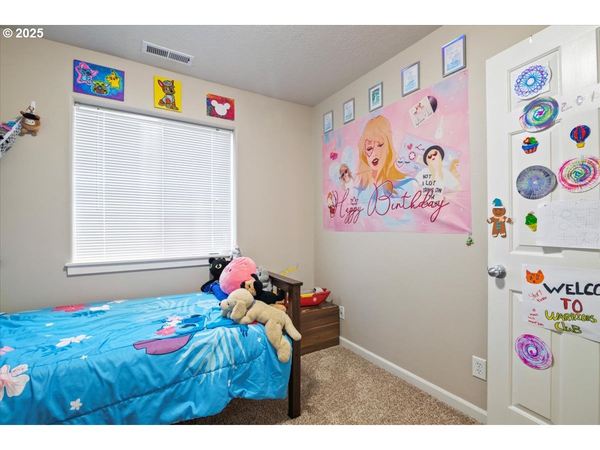 4135 Geranium Loop Northeast Salem, OR 97305 - Photo 17 of 18 a bedroom with toys and a bed