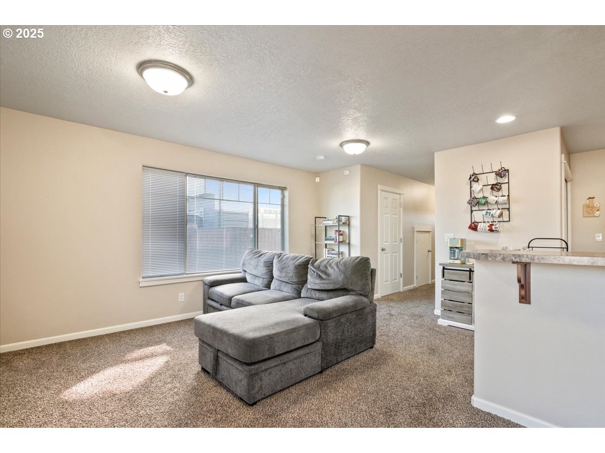 4135 Geranium Loop Northeast Salem, OR 97305 - Photo 6 of 18 a living room with furniture and a large window