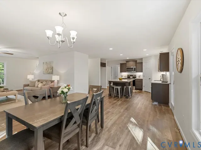 a view of a dining room with furniture and chandelier