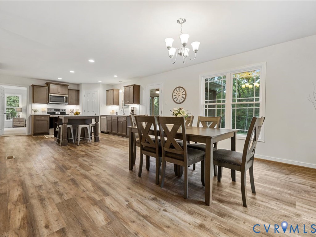1146 Clayton Road Powhatan, VA 23139 - Photo 13 of 42 a view of a dining room with furniture window and wooden floor