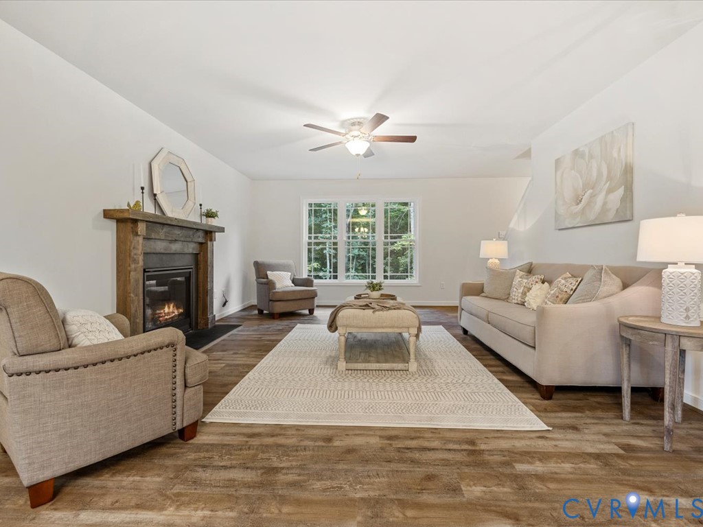 1146 Clayton Road Powhatan, VA 23139 - Photo 14 of 42 a living room with furniture a fireplace and a large window