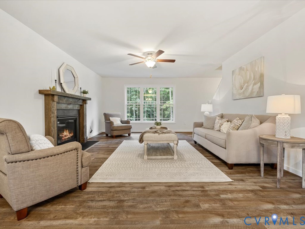 1146 Clayton Road Powhatan, VA 23139 - Photo 15 of 42 a living room with furniture a fireplace and a large window