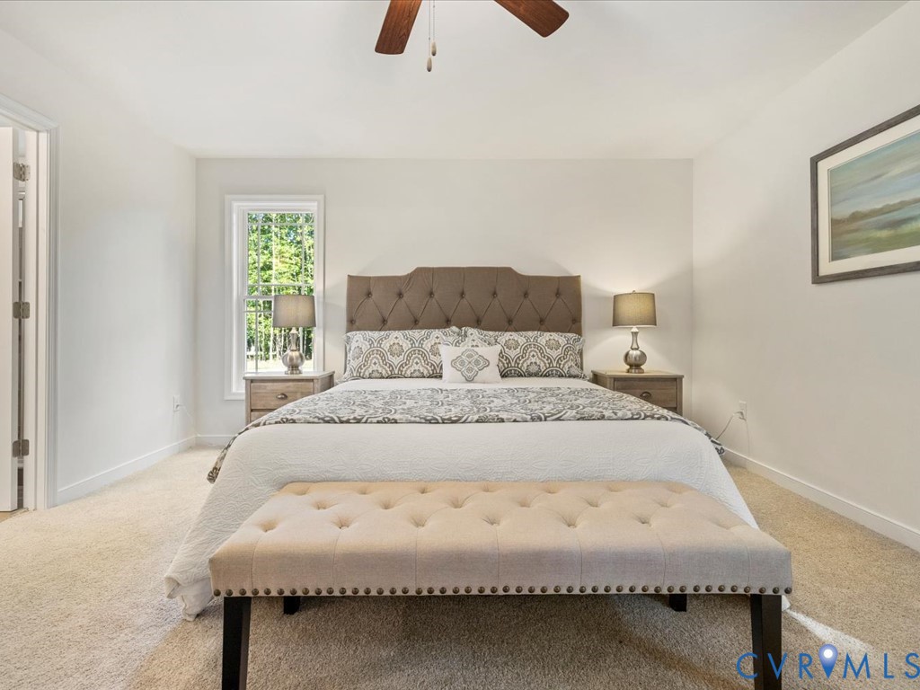 1146 Clayton Road Powhatan, VA 23139 - Photo 23 of 42 a large bed sitting in a bedroom next to a window