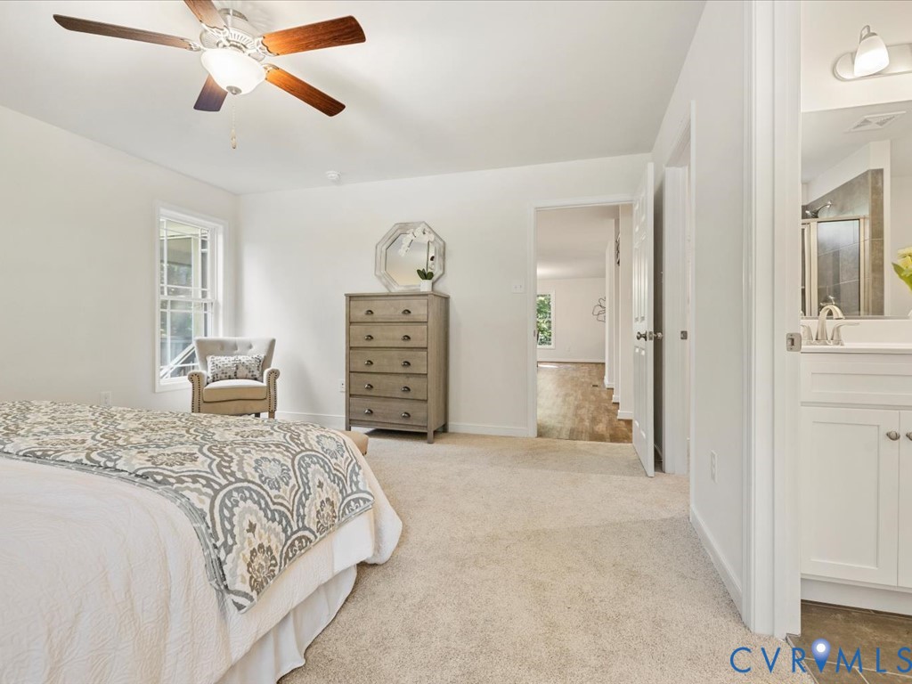 1146 Clayton Road Powhatan, VA 23139 - Photo 25 of 42 a bedroom with a large bed and a chandelier