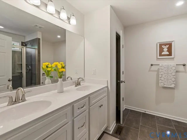 a bathroom with a double vanity sink and a mirror