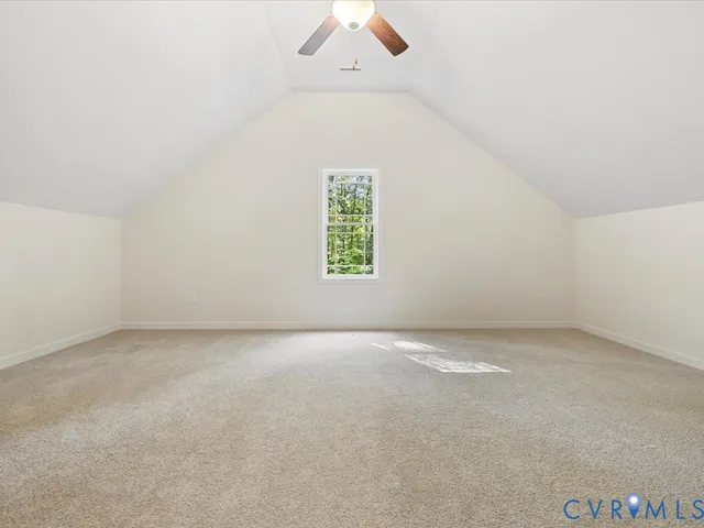 an empty room with a window and a ceiling fan