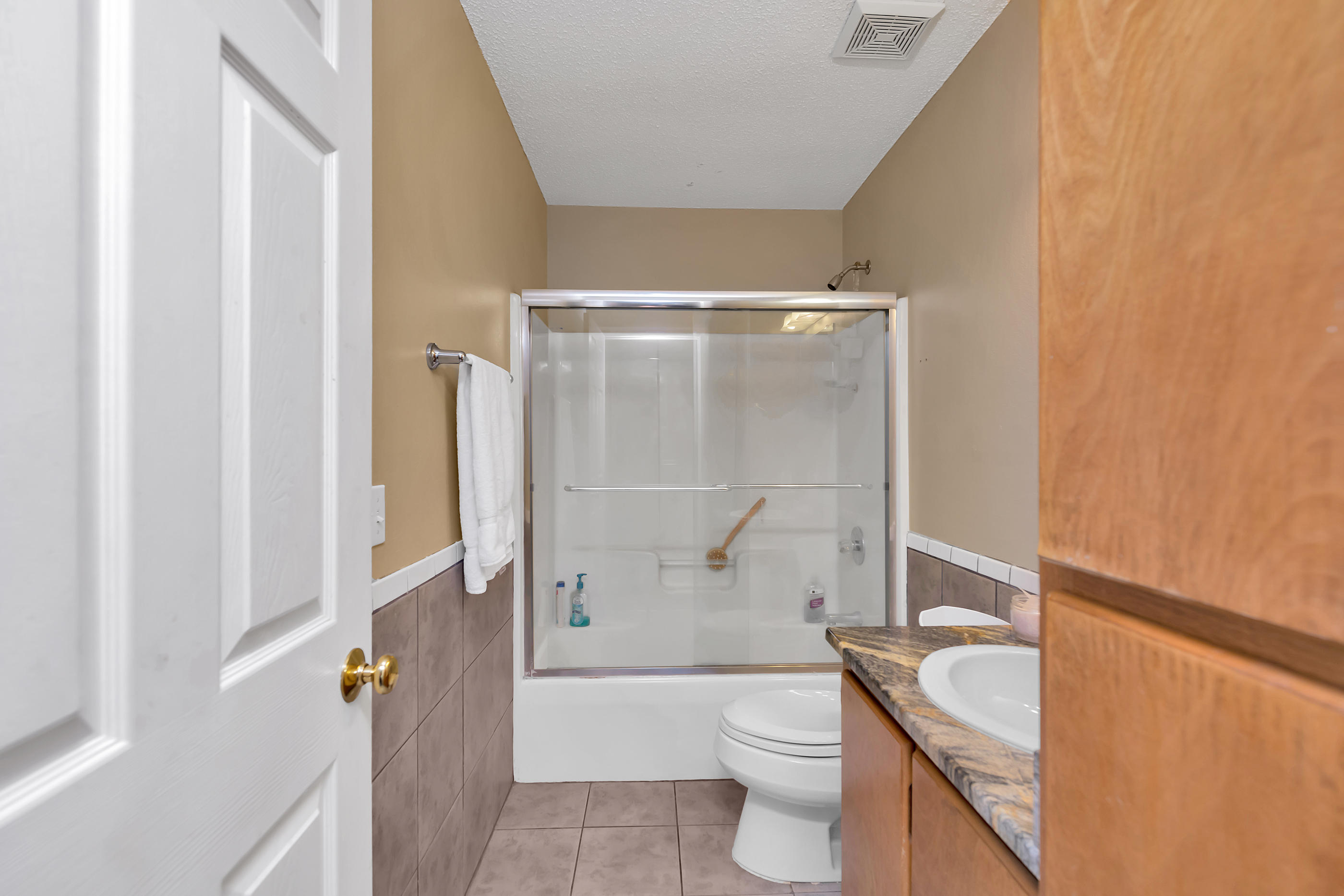 8757 Laredo Street Navarre, FL 32566 - Photo 11 of 14 a bathroom with a sink a toilet and a bathtub