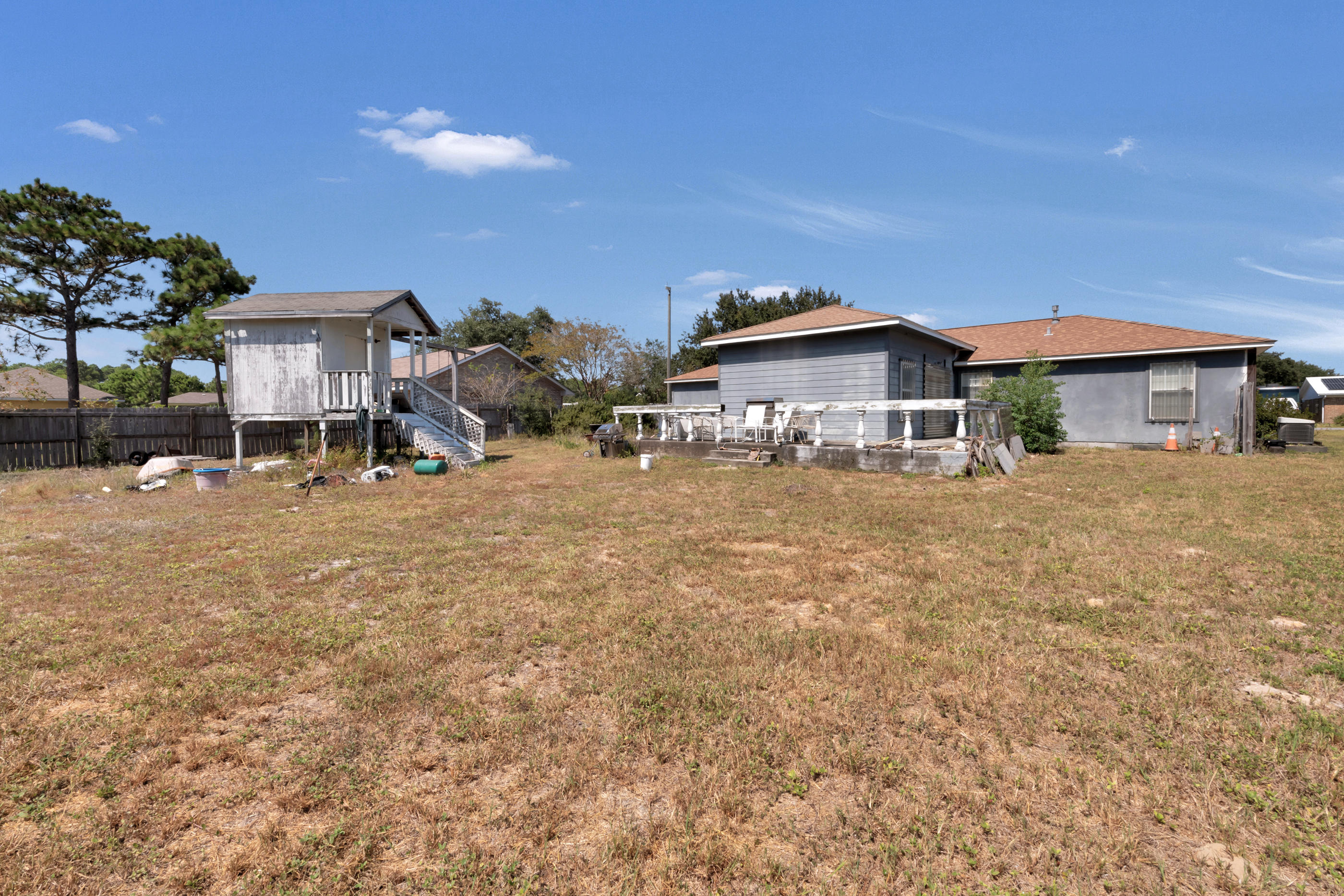 8757 Laredo Street Navarre, FL 32566 - Photo 13 of 14 a view of a house with a big yard and large trees