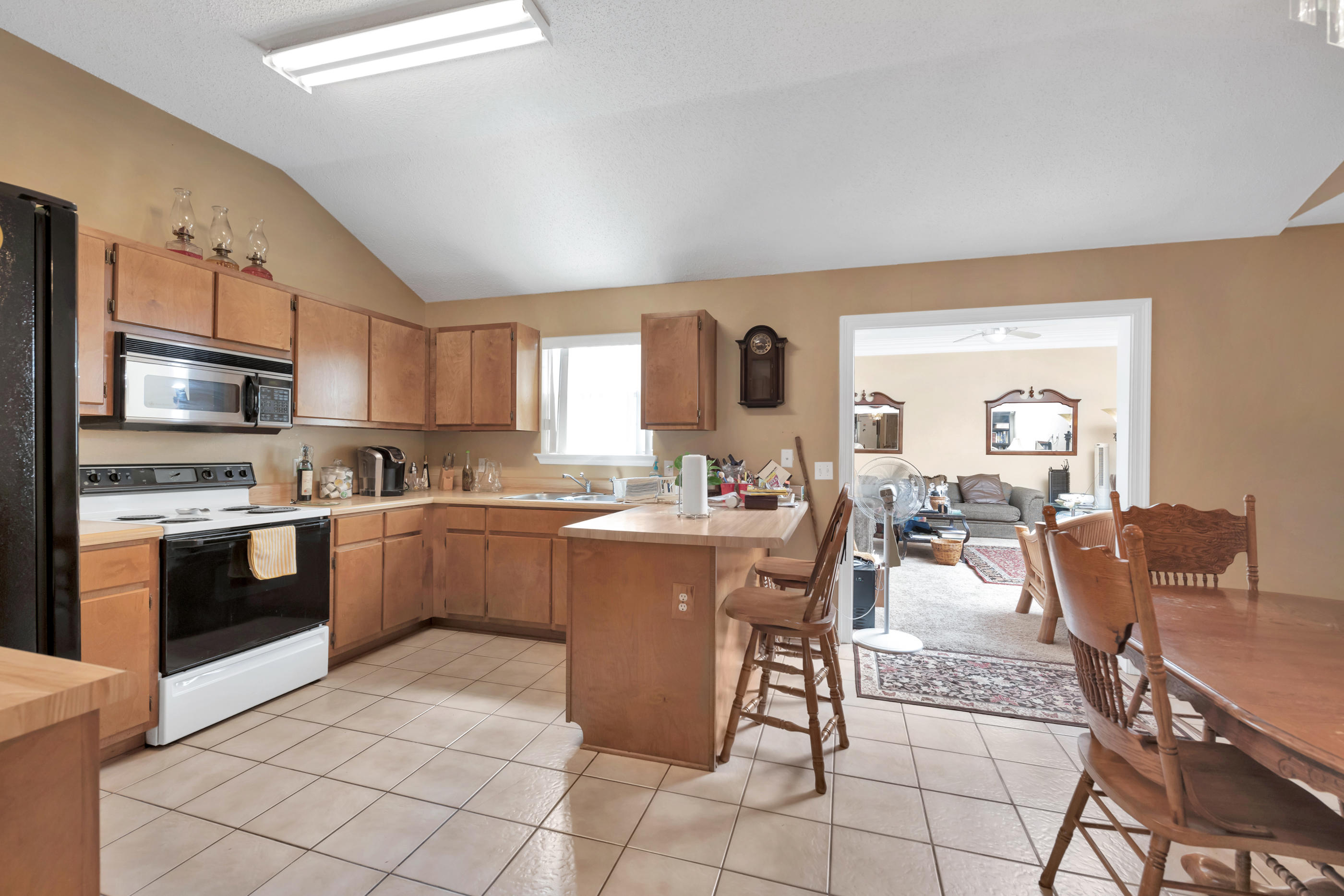 8757 Laredo Street Navarre, FL 32566 - Photo 6 of 14 a large kitchen with a table and chairs in it