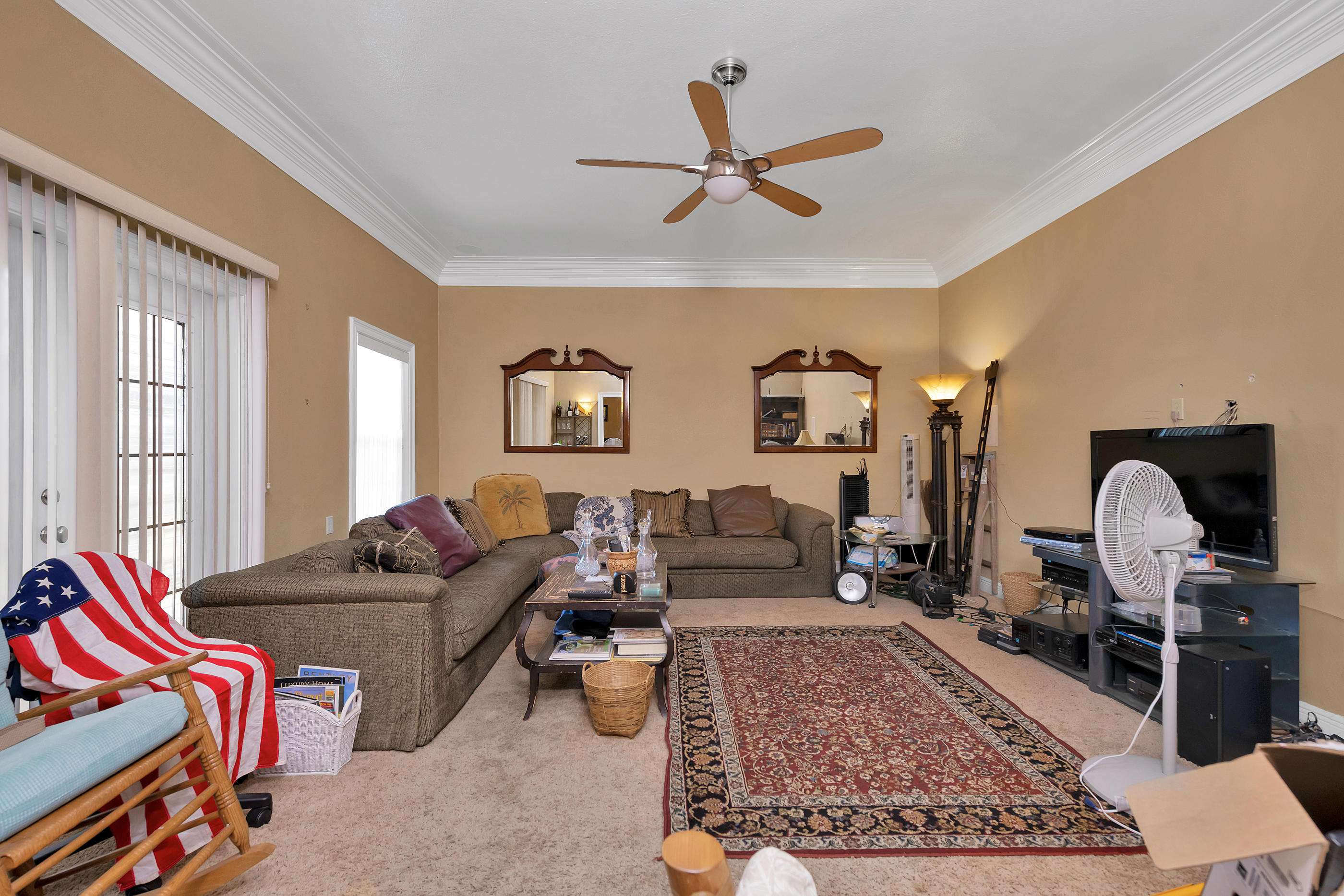 8757 Laredo Street Navarre, FL 32566 - Photo 7 of 14 a living room with furniture ceiling fan and a rug