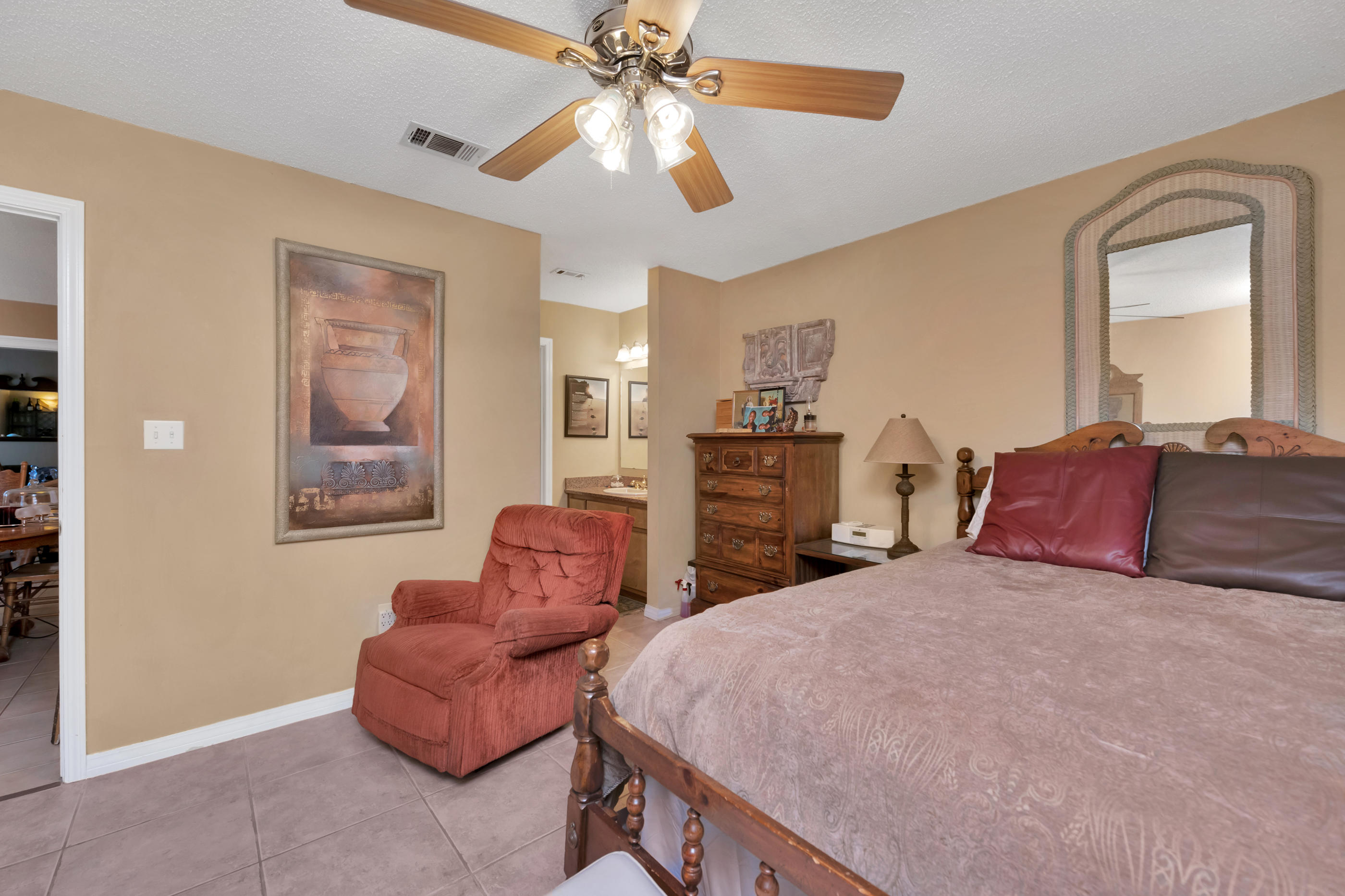 8757 Laredo Street Navarre, FL 32566 - Photo 9 of 14 a bedroom with a large bed and a chandelier