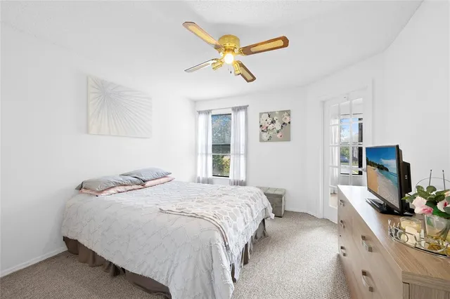 a bedroom with a bed and a flat tv screen on the dresser