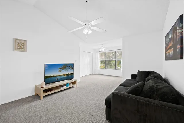 a living room with furniture gym equipment and a window