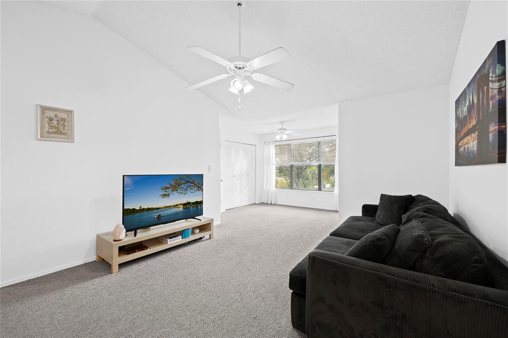 2736 South University Drive, Unit 1204 Davie, FL 33328 - Photo 17 of 23 a living room with furniture gym equipment and a window