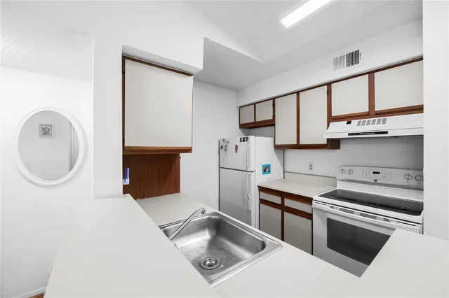 a kitchen with stainless steel appliances granite countertop a sink and a stove