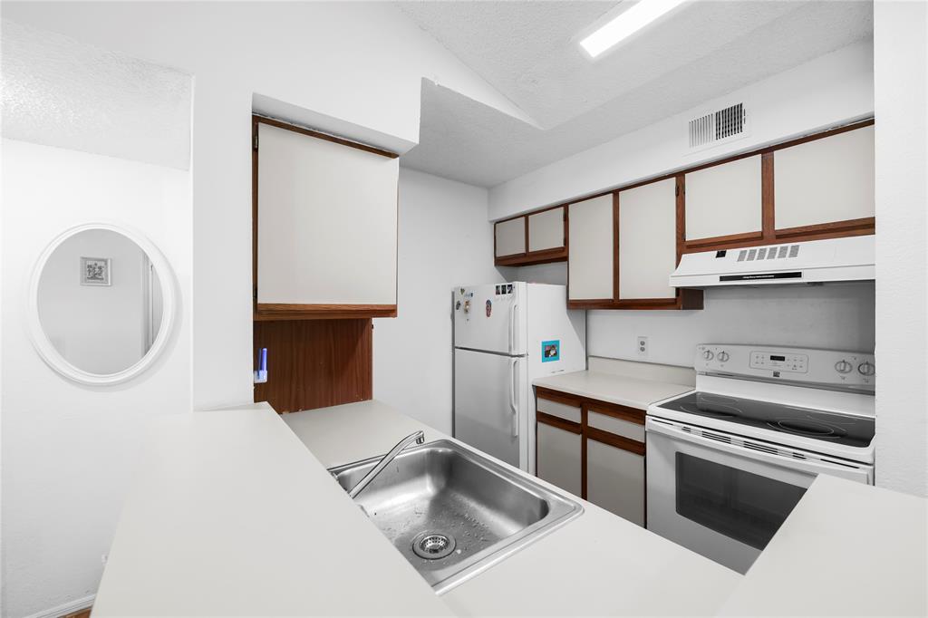 2736 South University Drive, Unit 1204 Davie, FL 33328 - Photo 5 of 23 a kitchen with stainless steel appliances granite countertop a sink and a stove