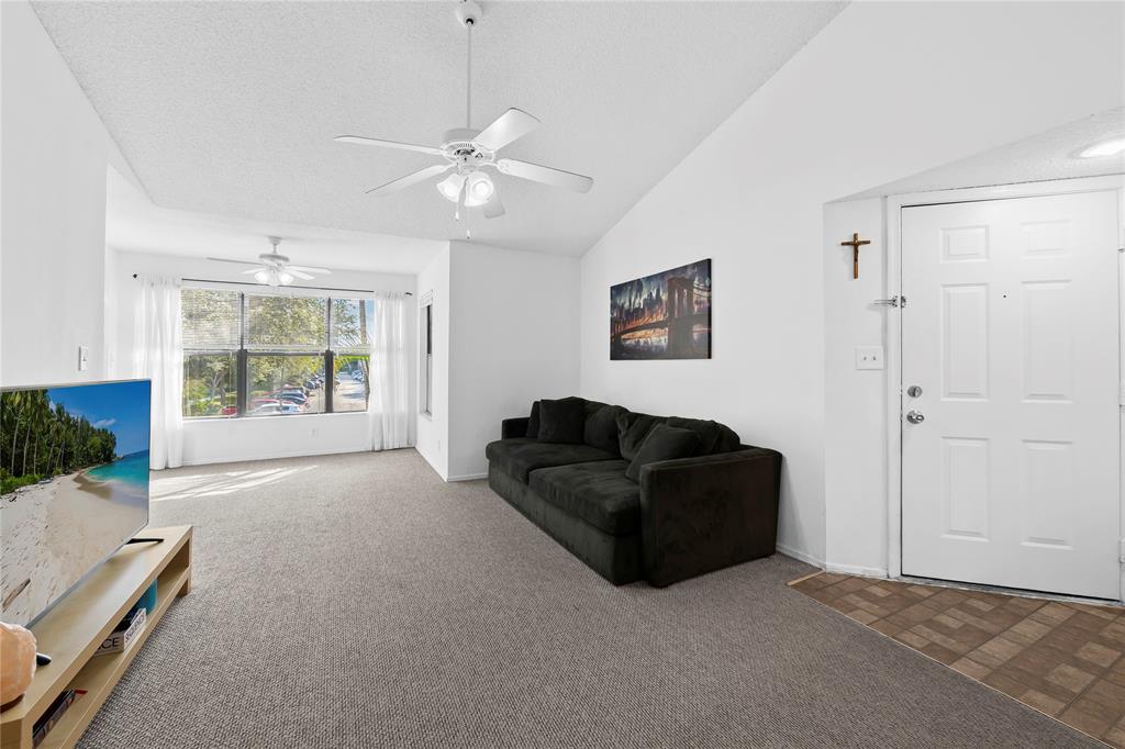 2736 South University Drive, Unit 1204 Davie, FL 33328 - Photo 8 of 23 a living room with furniture and a large window