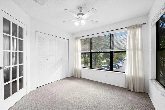 an empty room with windows and cabinet