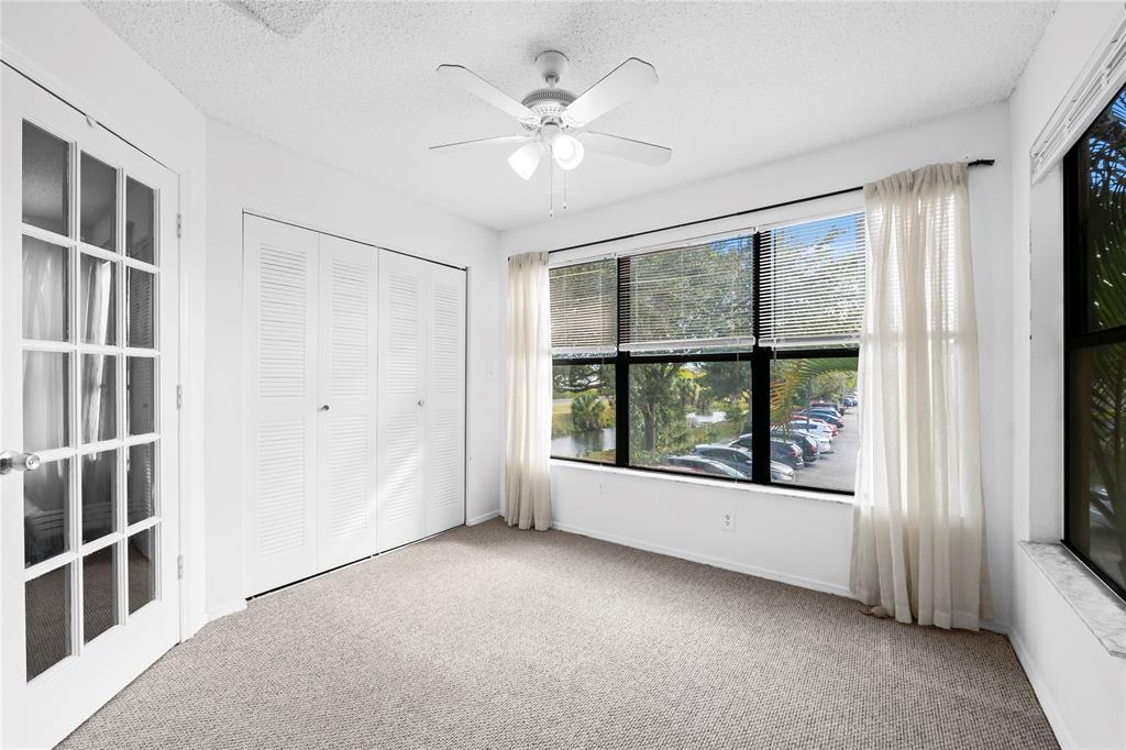 2736 South University Drive, Unit 1204 Davie, FL 33328 - Photo 9 of 23 an empty room with windows and cabinet