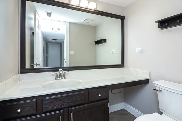 a bathroom with a sink a mirror and a toilet