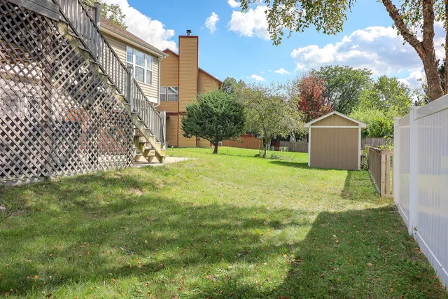 a garden with trees in front of it