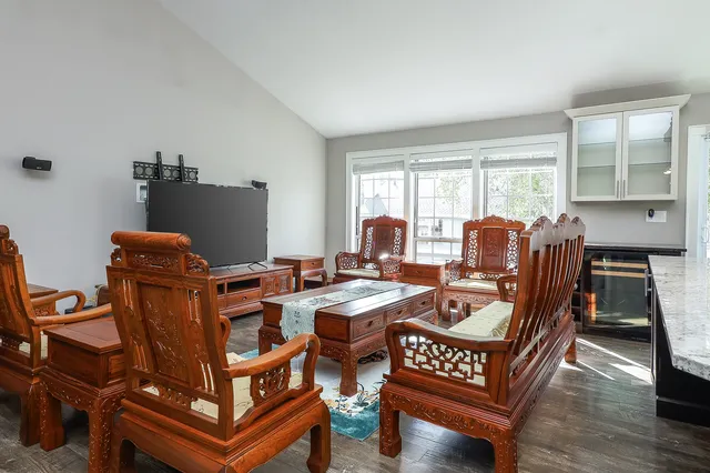 a view of a workspace with furniture and a window