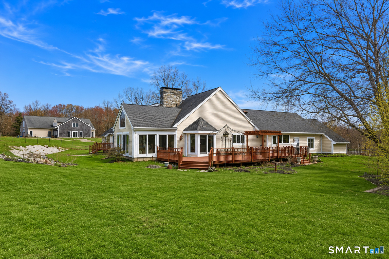 33 Meehan Road Woodstock, CT 06281 - Photo 1 of 39 Idyllic outdoor setting with a large entertaining deck, gently rolling lawn, and views extending toward the beautifully sited barn.