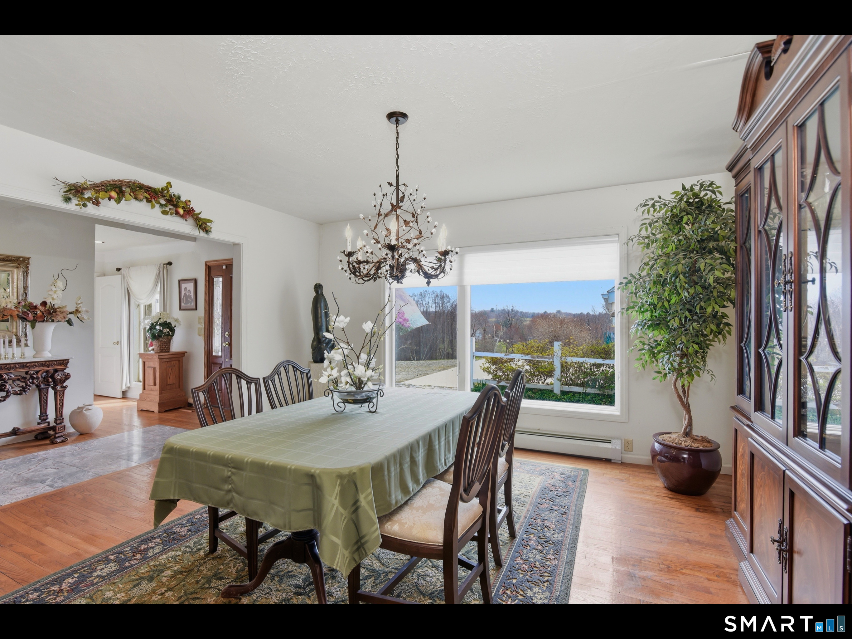 33 Meehan Road Woodstock, CT 06281 - Photo 11 of 39 The spacious formal dining room is enhanced by hardwood flooring, an elegant chandelier, and large picture window overlooking the pastoral countryside.