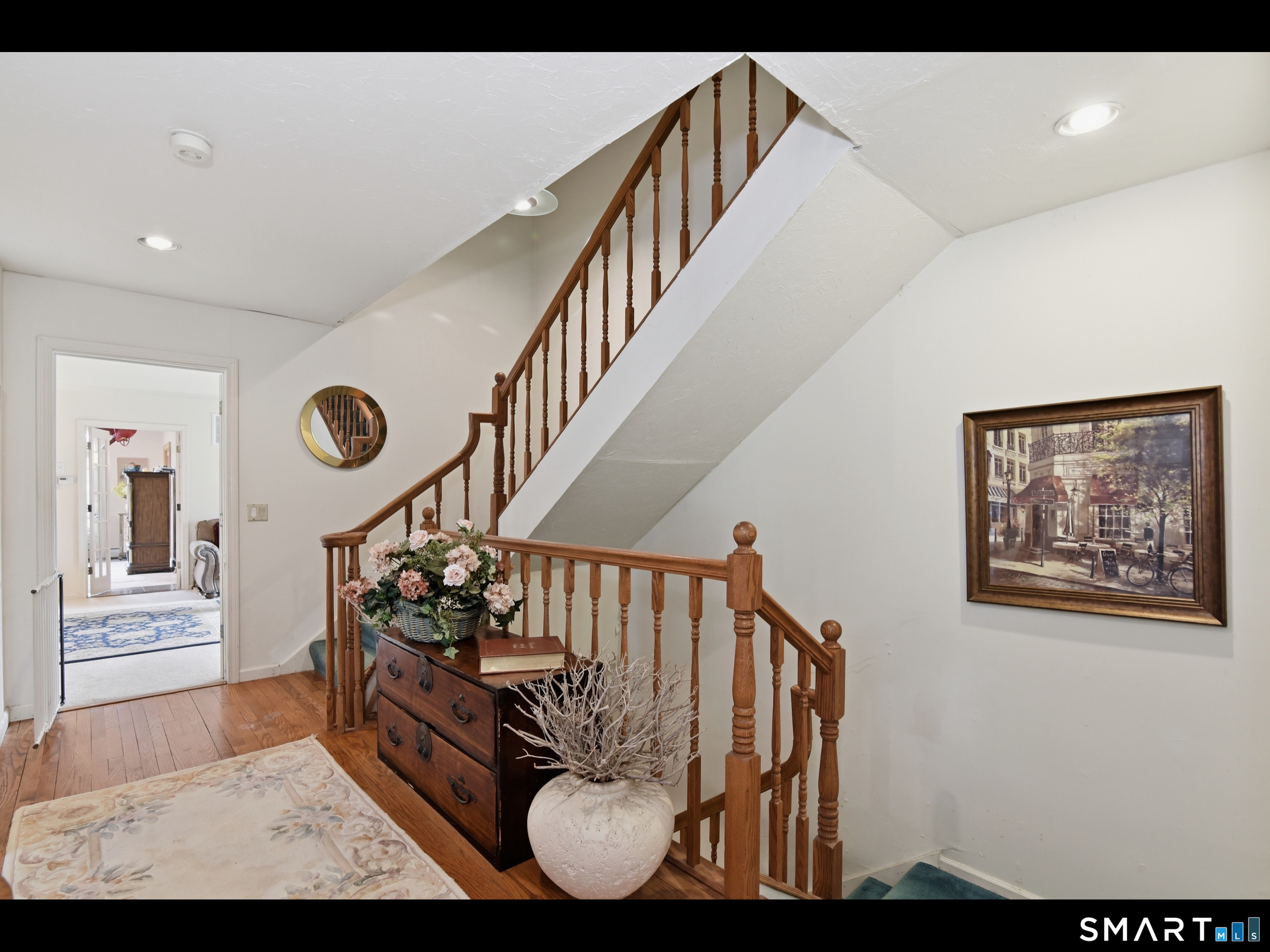 33 Meehan Road Woodstock, CT 06281 - Photo 19 of 39 Central hallway and staircase with classic wood balusters. Primary suite is positioned just beyond the landing.