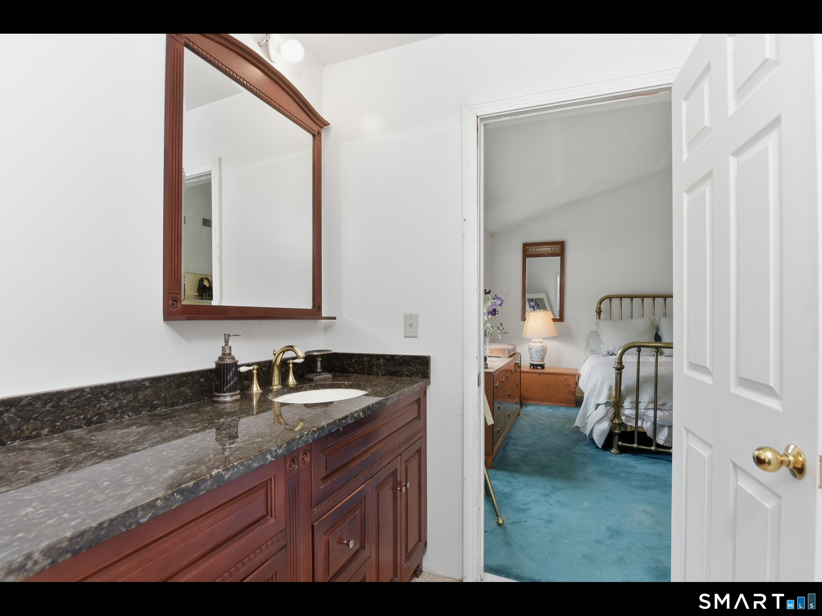 33 Meehan Road Woodstock, CT 06281 - Photo 22 of 39 The upstairs dual-access bathroom suite, nestled between the bedrooms, features a granite vanity washroom outside the bathroom.