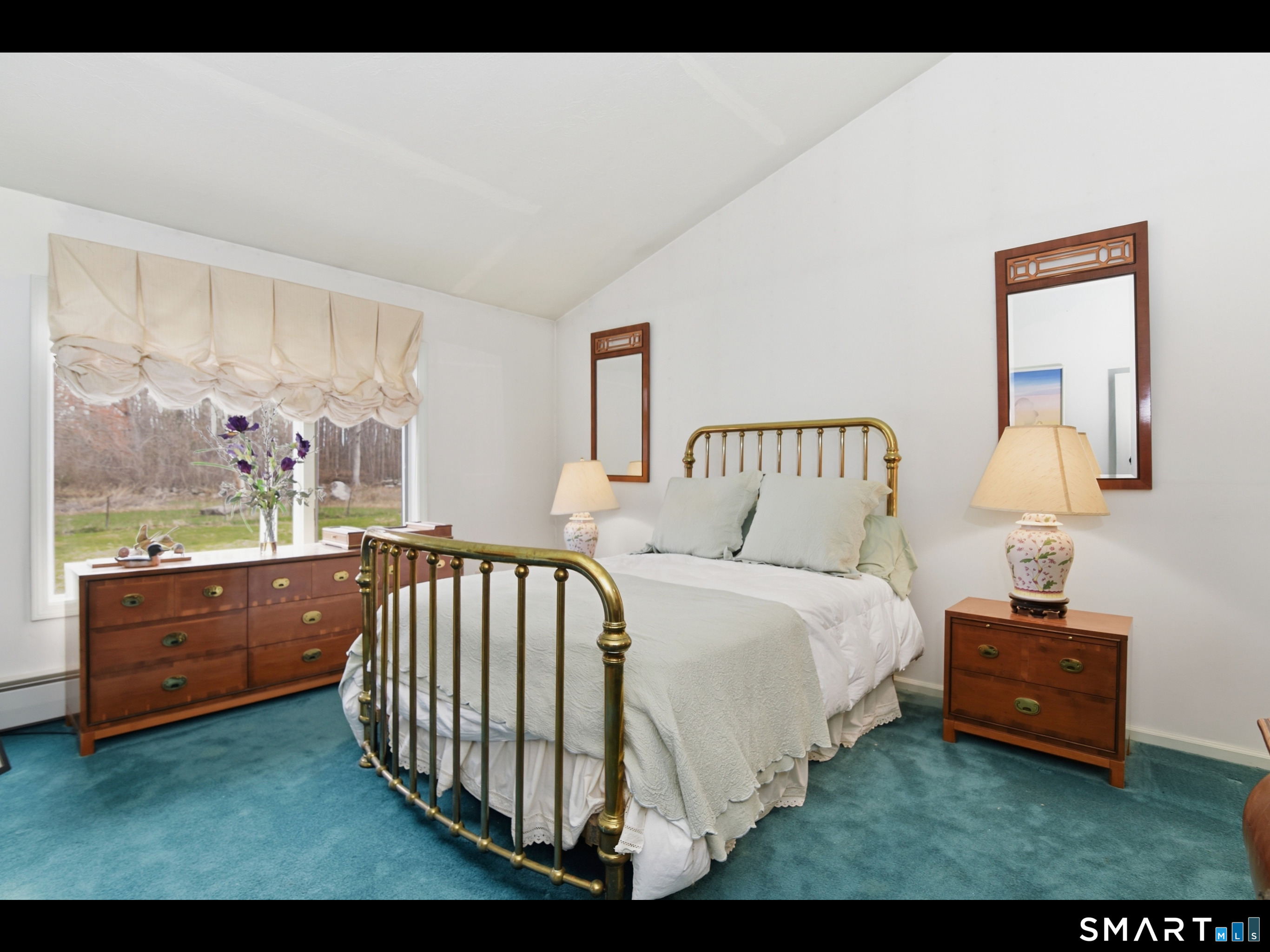 33 Meehan Road Woodstock, CT 06281 - Photo 23 of 39 Bedroom 2 is located on the upper level and offers a generously sized, serene retreat, with a high vaulted ceiling, expansive windows, and direct access to the shared dual-entry bathroom.