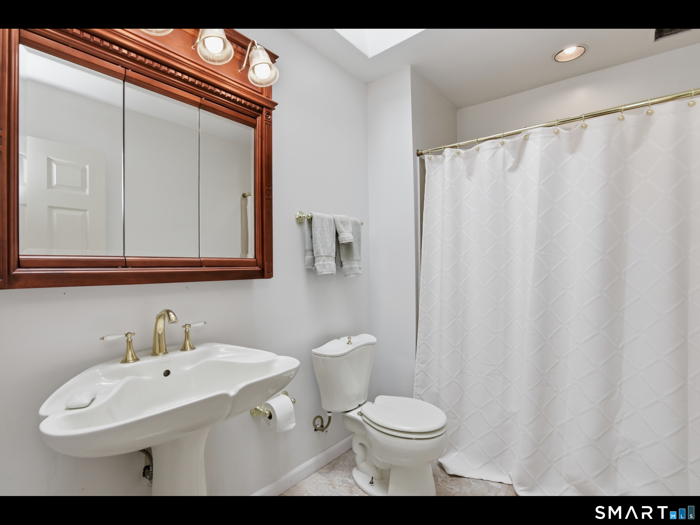 33 Meehan Road Woodstock, CT 06281 - Photo 24 of 39 The upper level dual-entry bathroom is appointed with a tub shower and a pedestal sink, in addition to the vanity sink in the adjoining washroom.