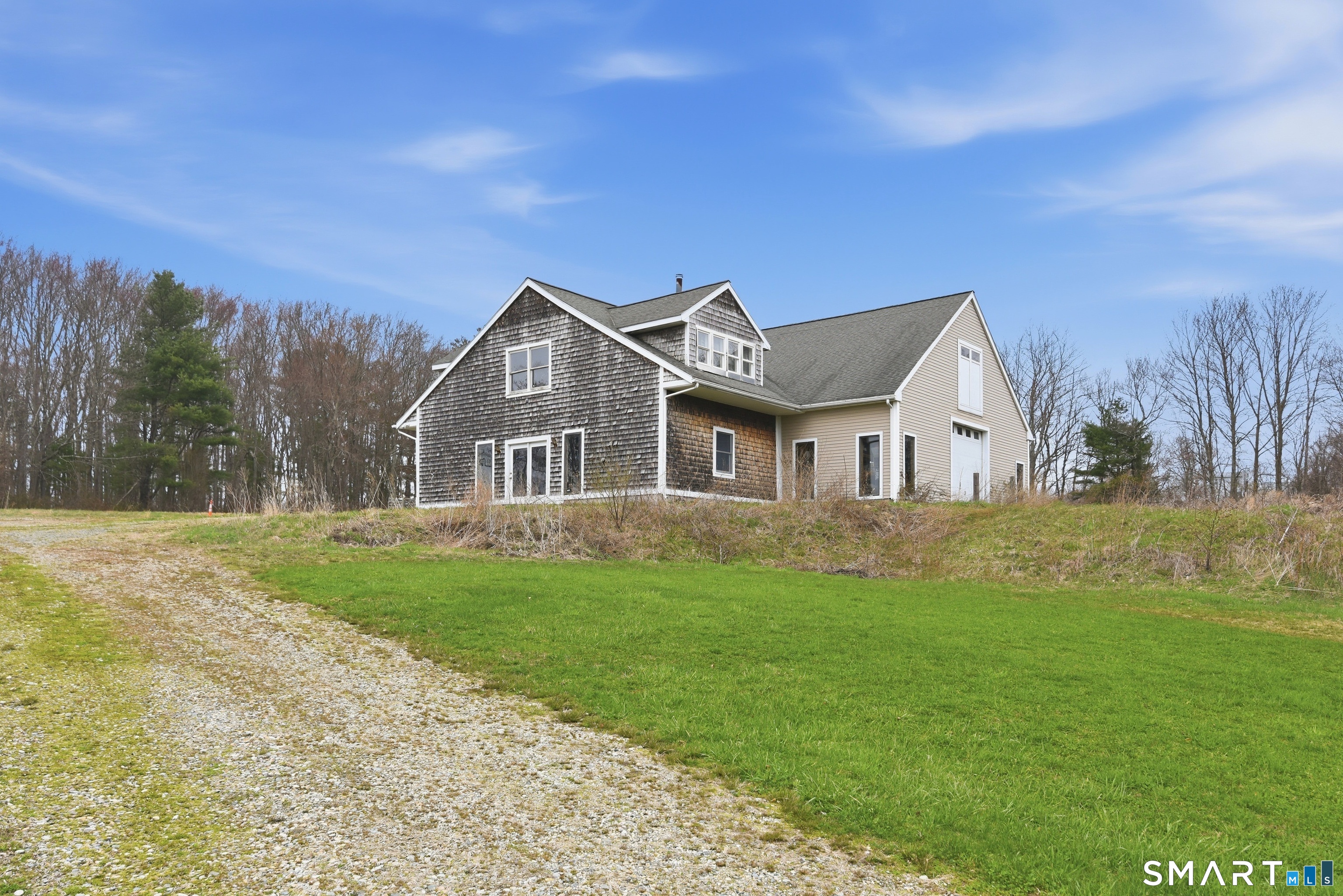 33 Meehan Road Woodstock, CT 06281 - Photo 4 of 39 Impressive 74-foot-long barn/garage offers over 4,100 square feet with office area, half bath, furnace, two oversized garage doors, horse stall locations, and potential future living space on 2nd floor.