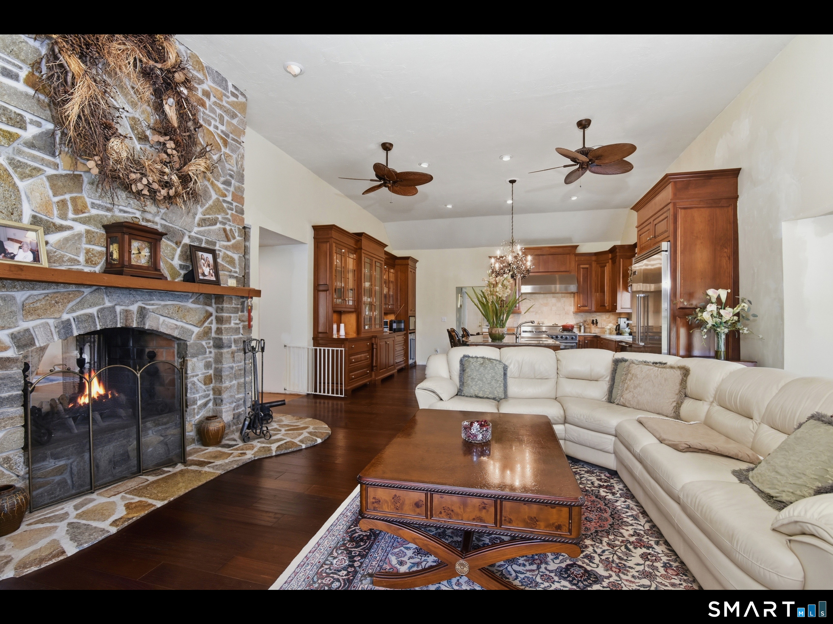 33 Meehan Road Woodstock, CT 06281 - Photo 8 of 39 The kitchen flows into the family room which is anchored by an impressive floor-to-ceiling stone fireplace Note the handsome wood mantel and classic arched firebox detail.