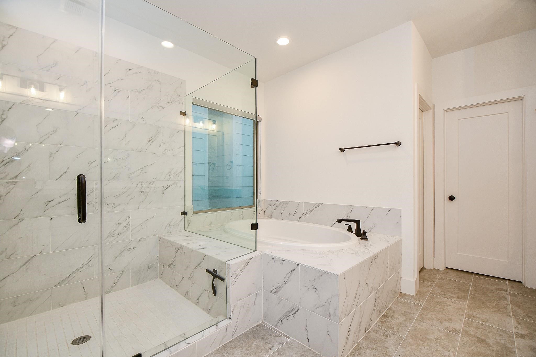 4403 Greeley Street Houston, TX 77006 - Photo 19 of 28 a bathroom with a bathtub and a shower