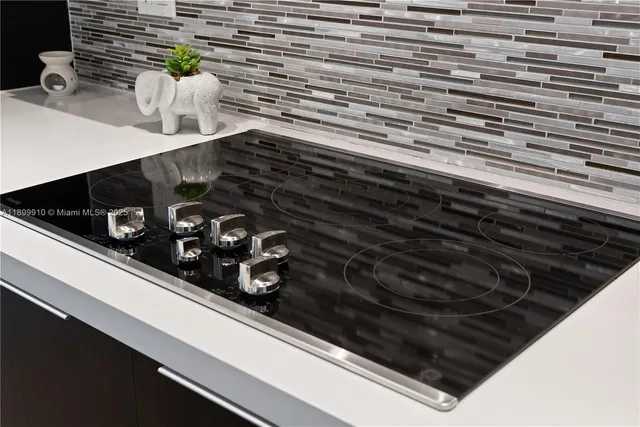 a close view of shoes and a stove with wooden floor