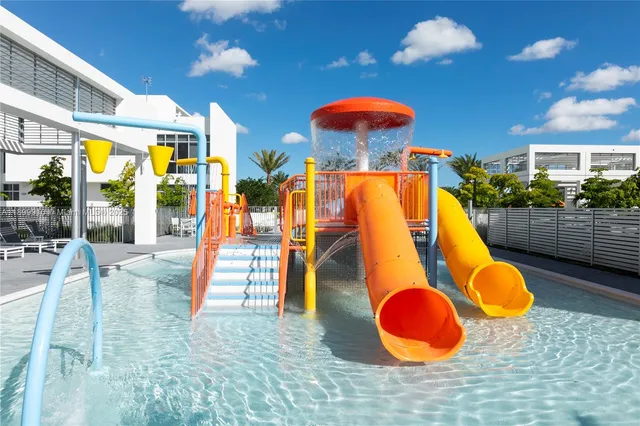 a view of a swimming pool with a yard and seating area