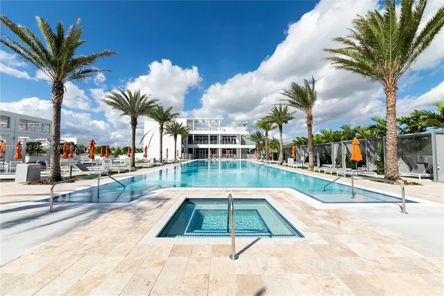 a view of a swimming pool with outdoor seating