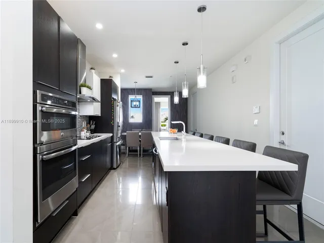 a large kitchen with a table and chairs