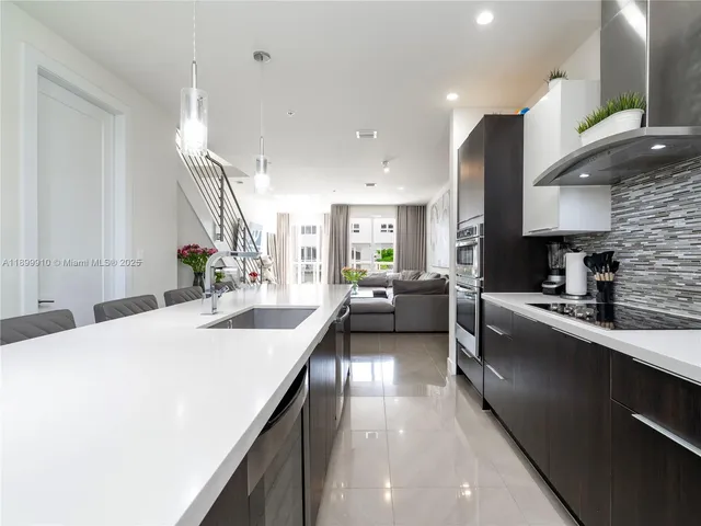 a kitchen with counter top space a sink and appliances