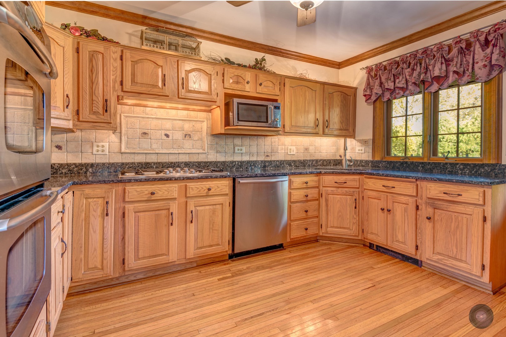 933 North Main Street Glen Ellyn, IL 60137 - Photo 11 of 32 a kitchen with stainless steel appliances granite countertop a sink and cabinets with wooden floor