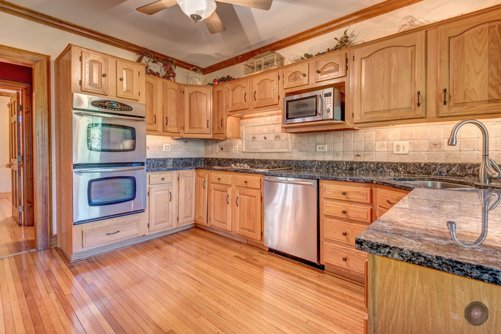 933 North Main Street Glen Ellyn, IL 60137 - Photo 12 of 32 a kitchen with stainless steel appliances granite countertop a stove and a sink